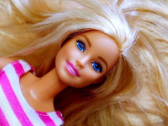 closeup of barbie doll in a pink and white striped shirt