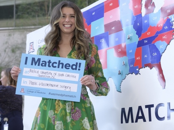 Alexandra Dominianni celebrates during Match Day while holding a sign that says I Matched