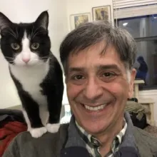 Fabian Alfie with a cat on their shoulder